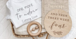 ‘One more to adore’ Pregnancy Announcement Onesie | Standard Font